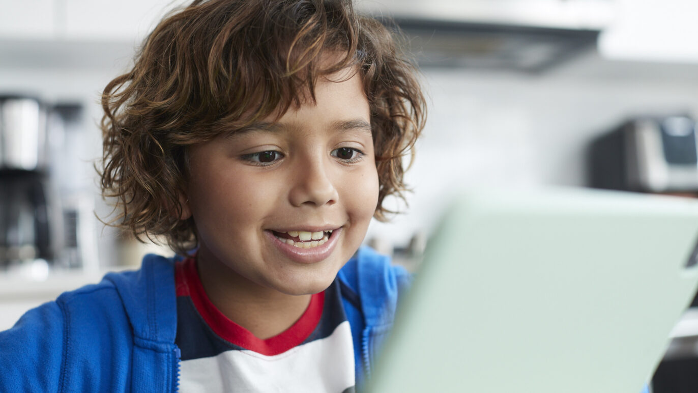 Child reading out loud to a voice-enabled product